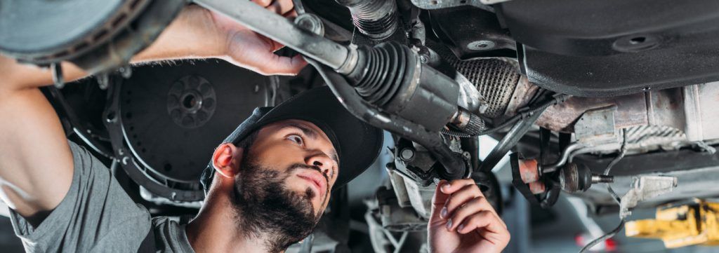 Mechanic looking underneath a vehicle - Car Repairs Bournemouth